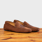 A Pair of Brick loafer with embroidery on a wooden surface
