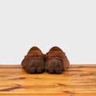 Brick loafer with embroidery on a wooden surface