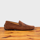 Brick loafer with embroidery on a wooden surface