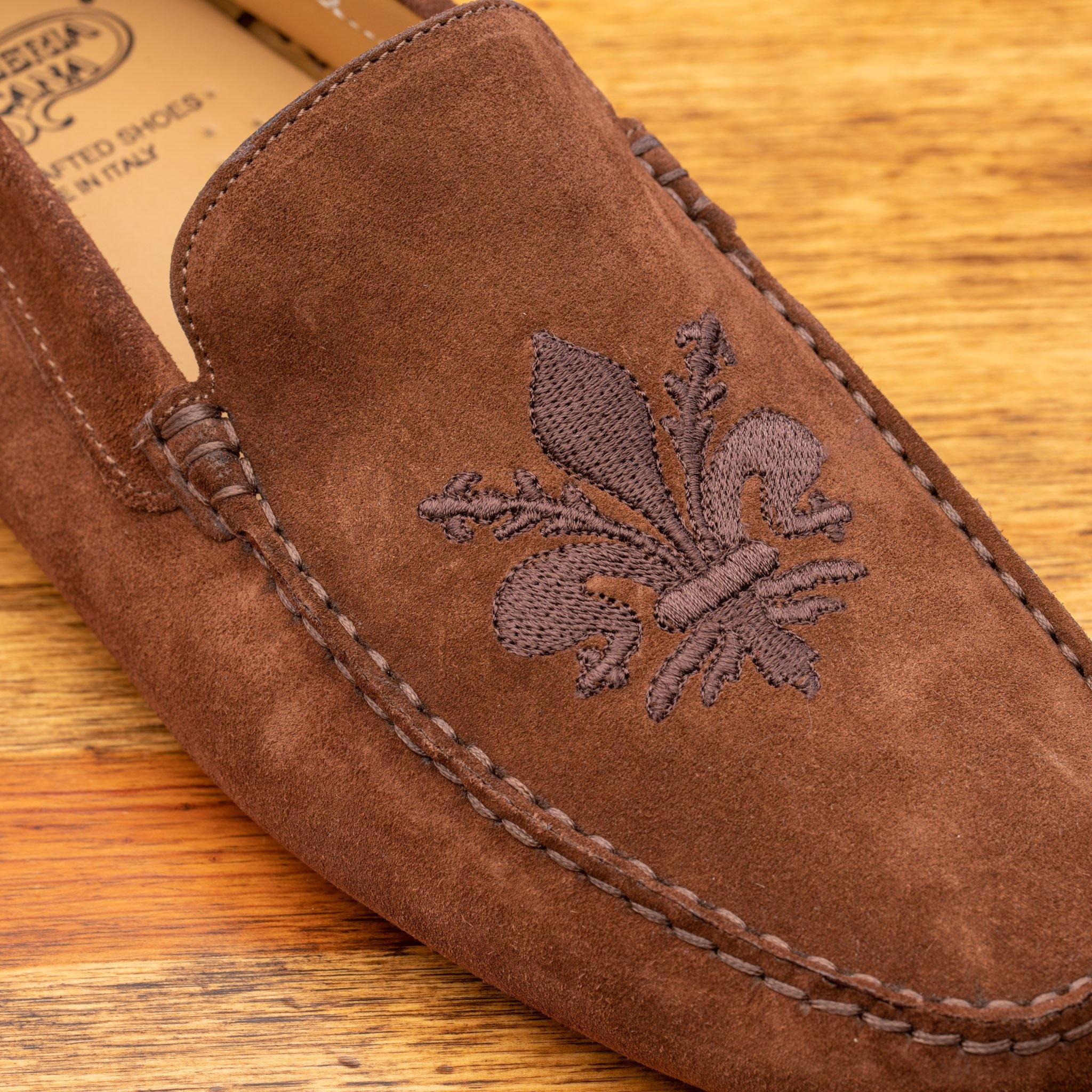 Brick loafer with embroidery on a wooden surface