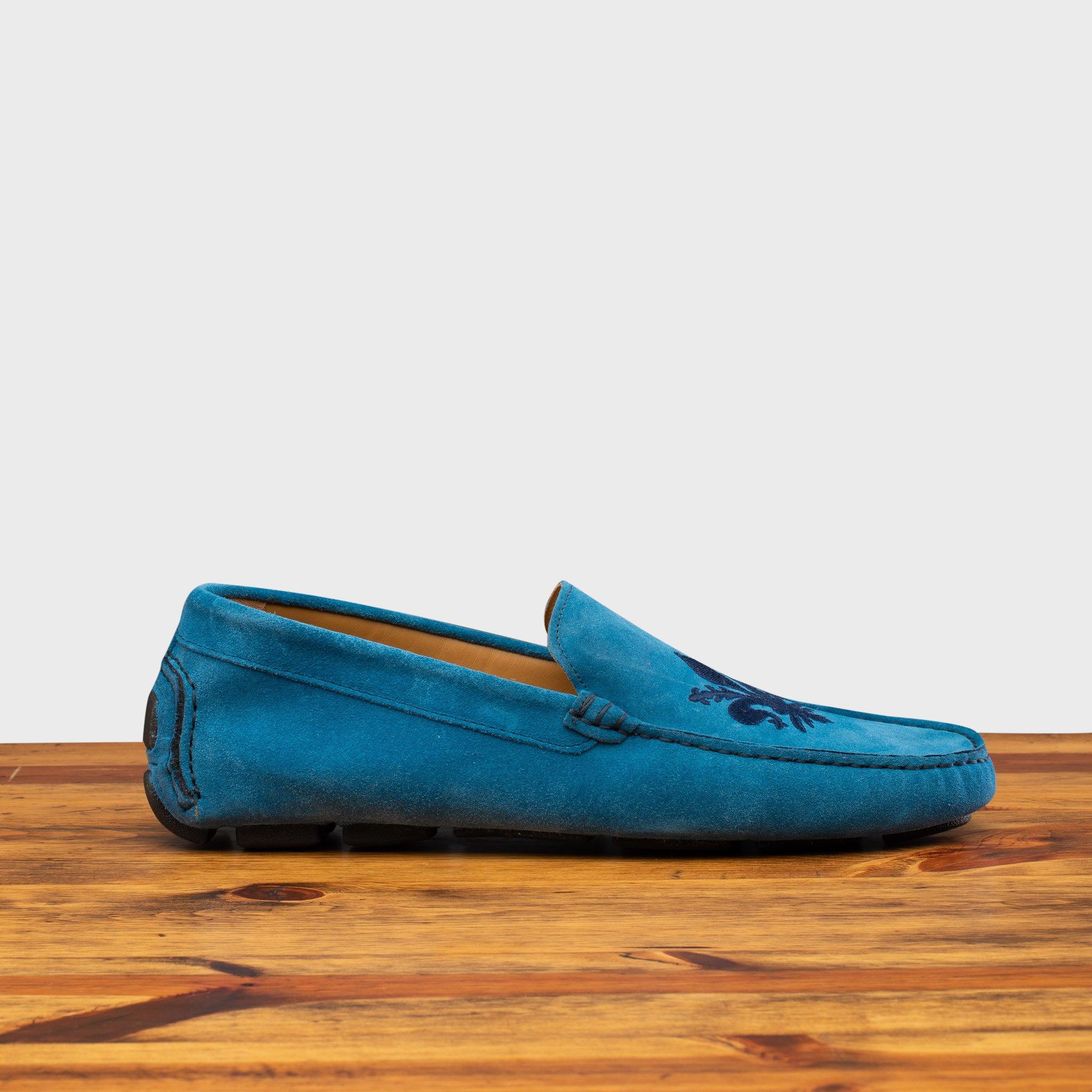 Denim loafer with embroidery on a wooden surface