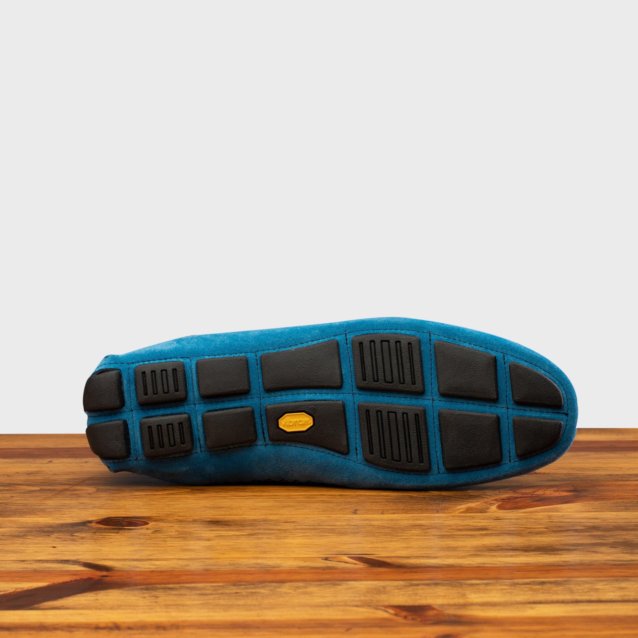 Outsole of Denim loafer with embroidery on a wooden surface