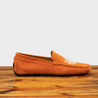Papaya loafer with embroidery on a wooden surface