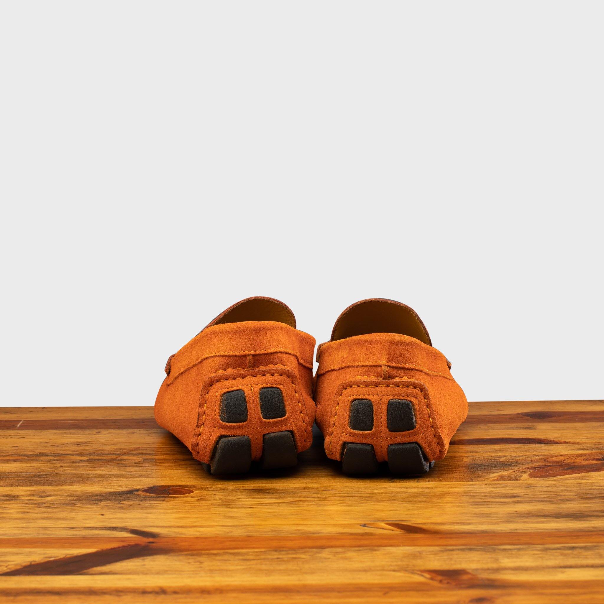 Papaya loafer with embroidery on a wooden surface