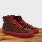 A Pair of Cherry high-top sneaker with woven pattern on a wooden surface