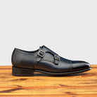 Blue leather shoe with Double buckle on a wooden surface