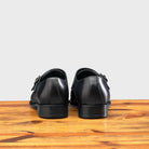 A Pair of Blue leather shoe with Double buckle on a wooden surface