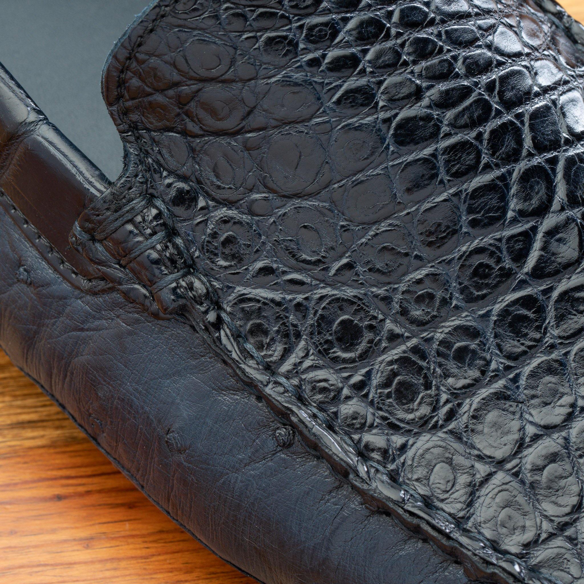 Close view of Blue leather loafer on a wooden surface 