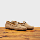 A pair of rope velour suede driver shoes with a metallic bit, placed on a wooden surface.