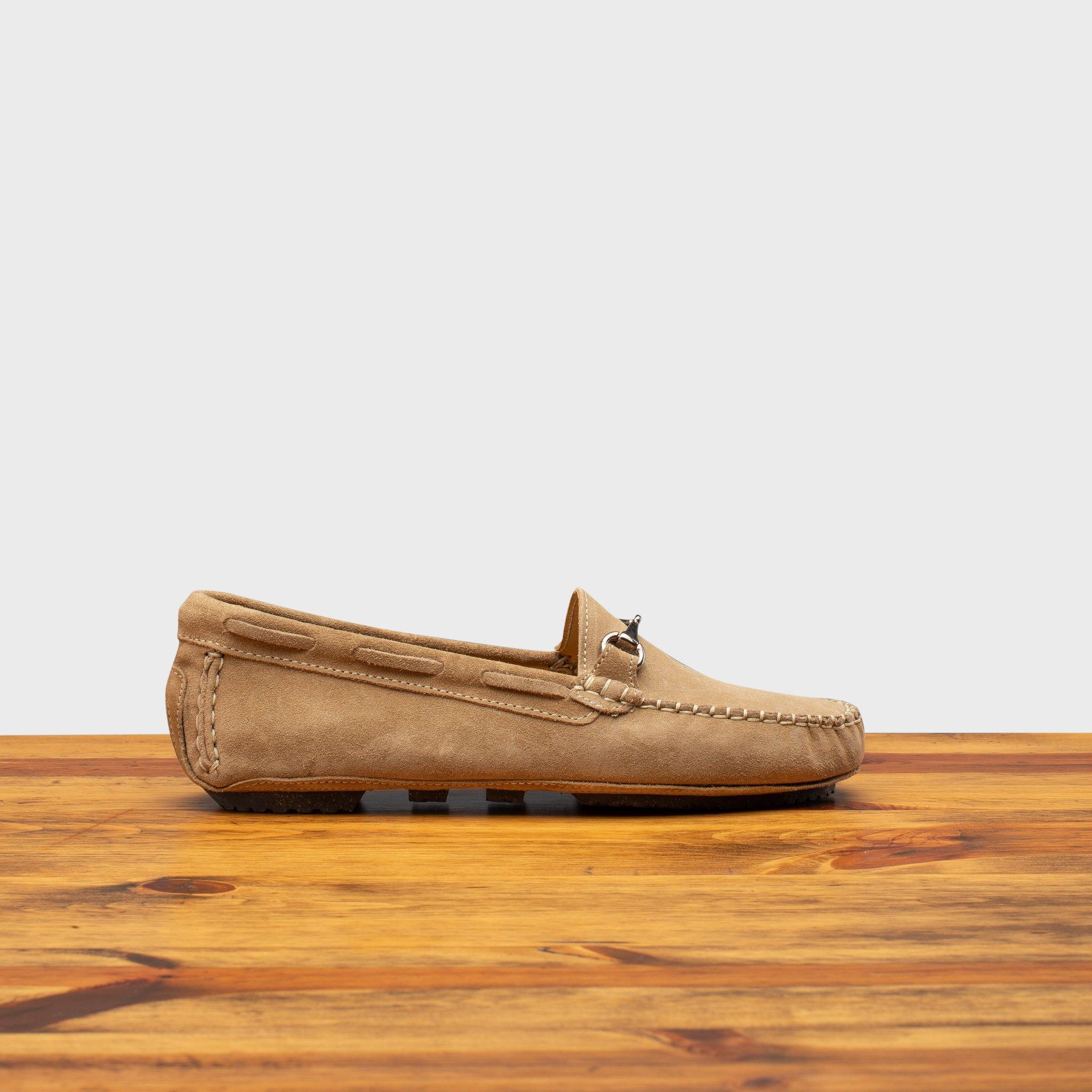 Rope velour suede driver shoes with a metallic bit, placed on a wooden surface.