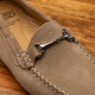 Rope velour suede driver shoes with a metallic bit, placed on a wooden surface.