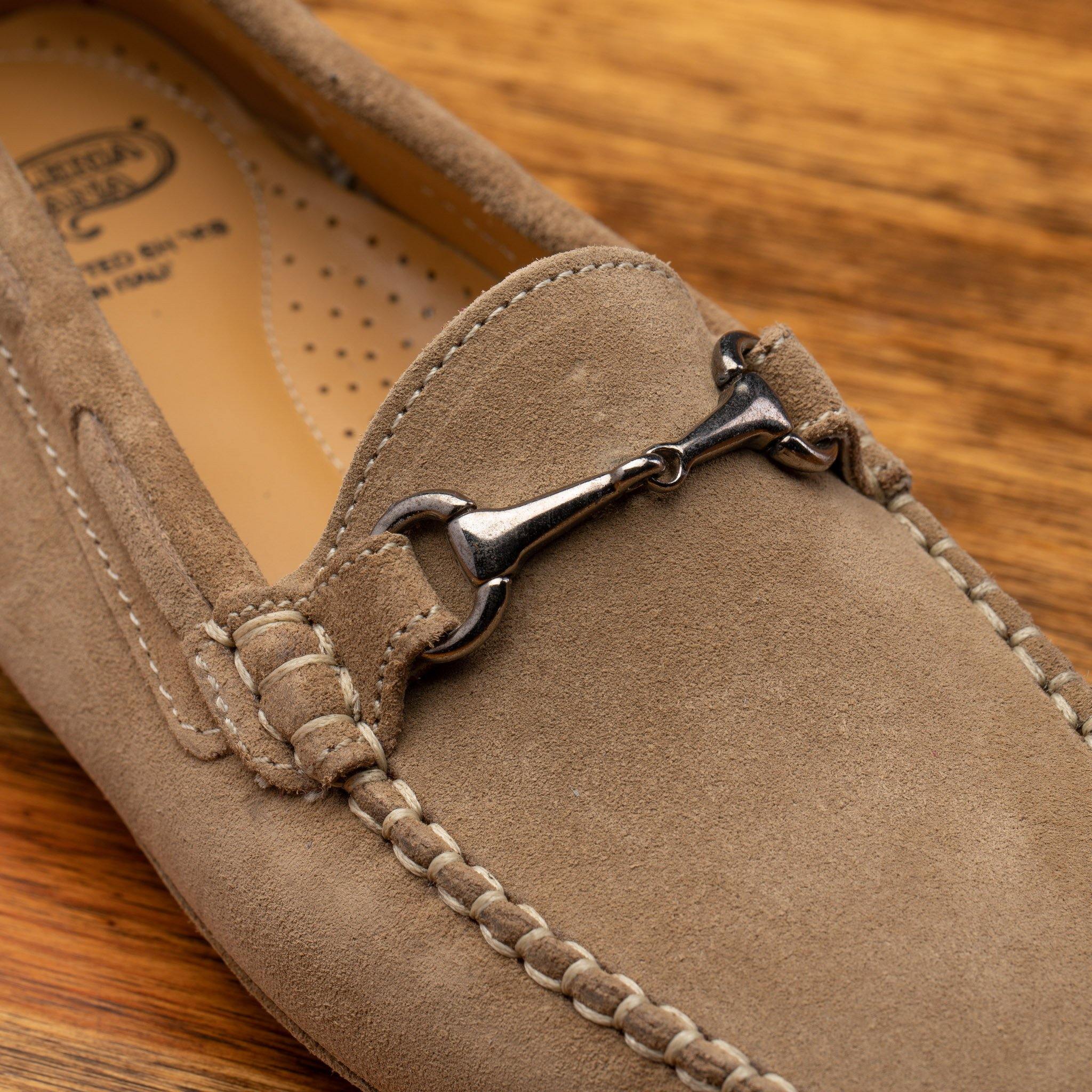 Rope velour suede driver shoes with a metallic bit, placed on a wooden surface.