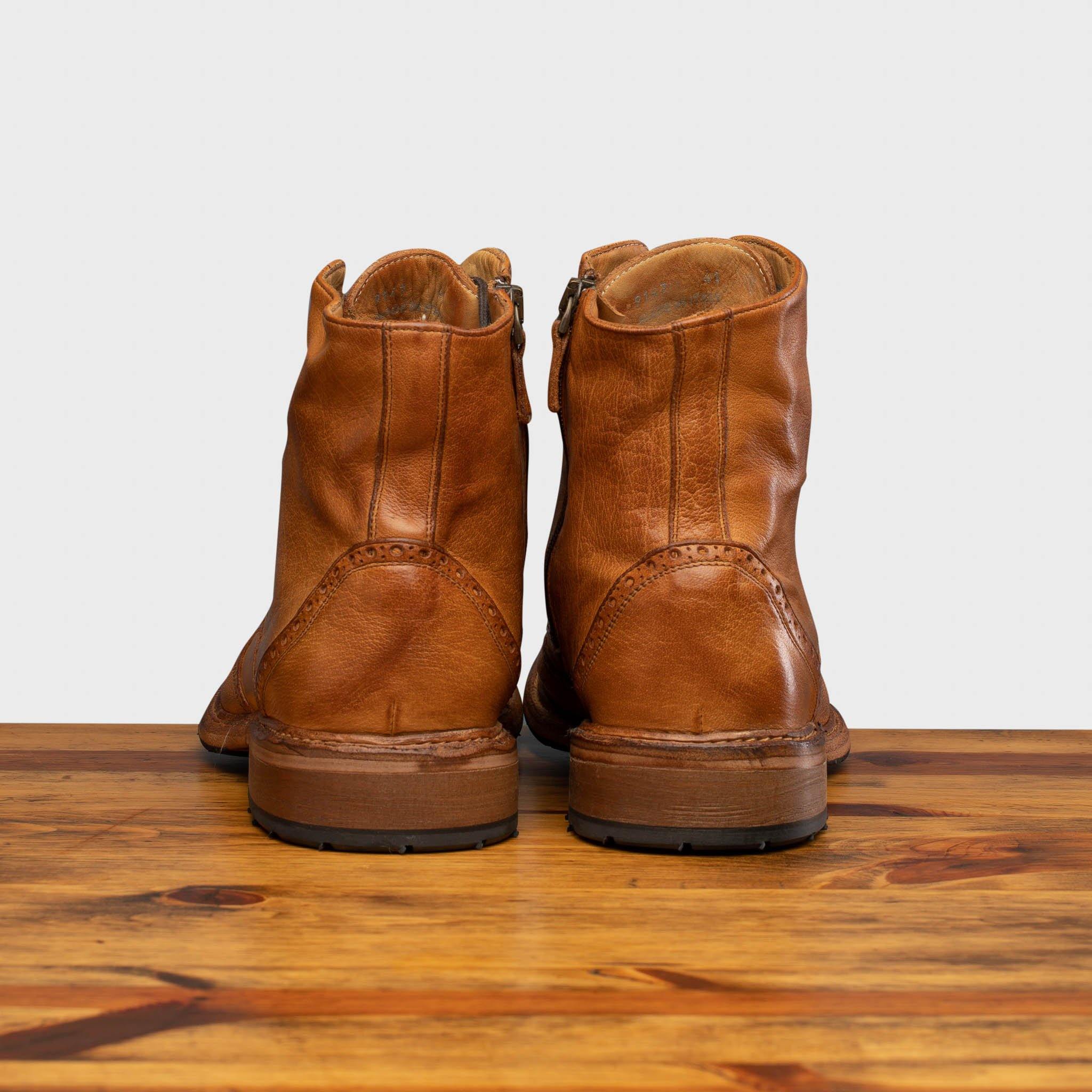 Pair of Brick leather boots on a wooden surface with a light gray background
