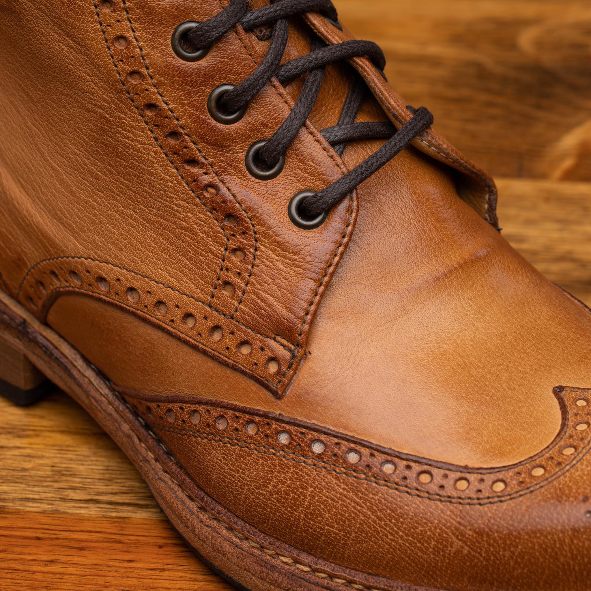 Brick leather boots on a wooden surface