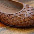 Brick woven flat shoe on a wooden 