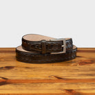 Dark Brown leather belt with a silver buckle on a wooden surface