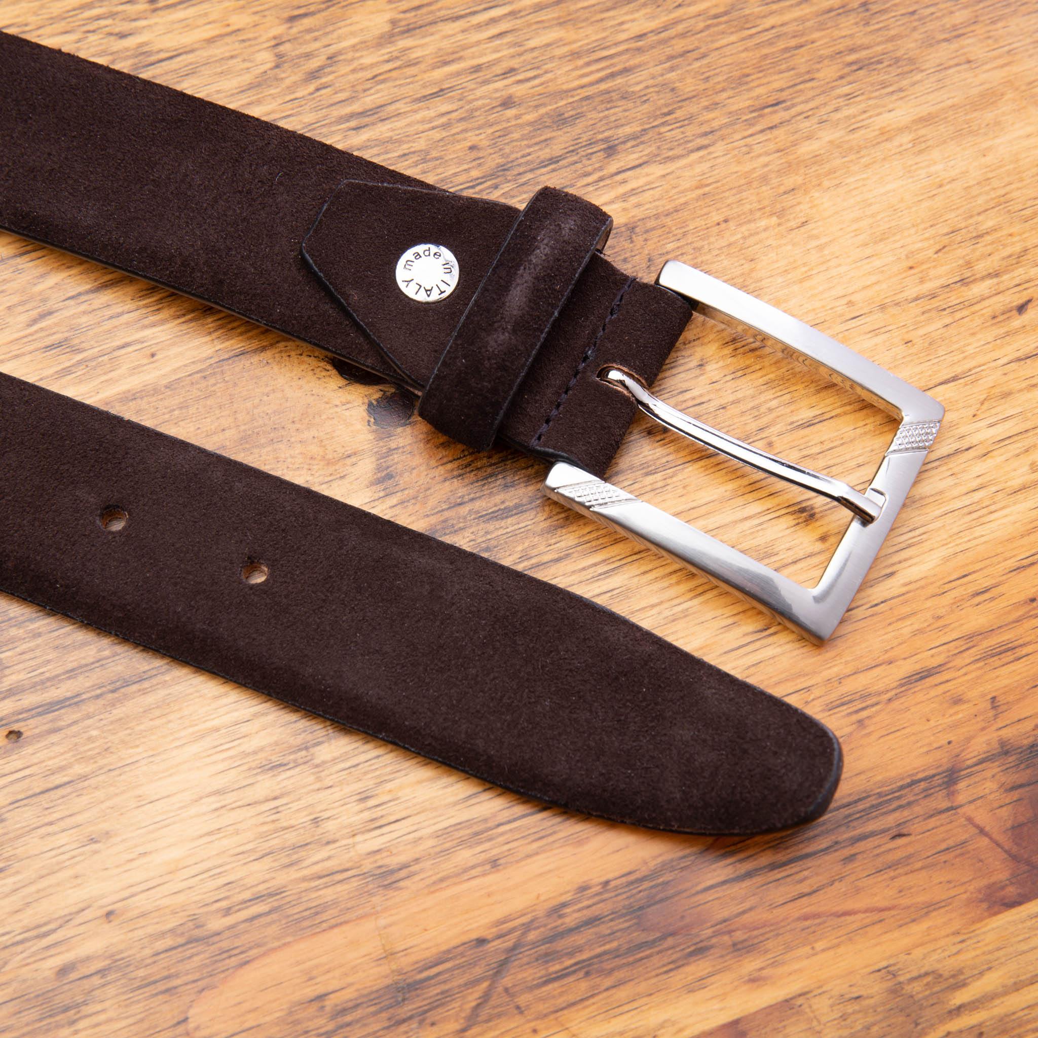 Chocolate Brown belt with a silver buckle on a wooden surface