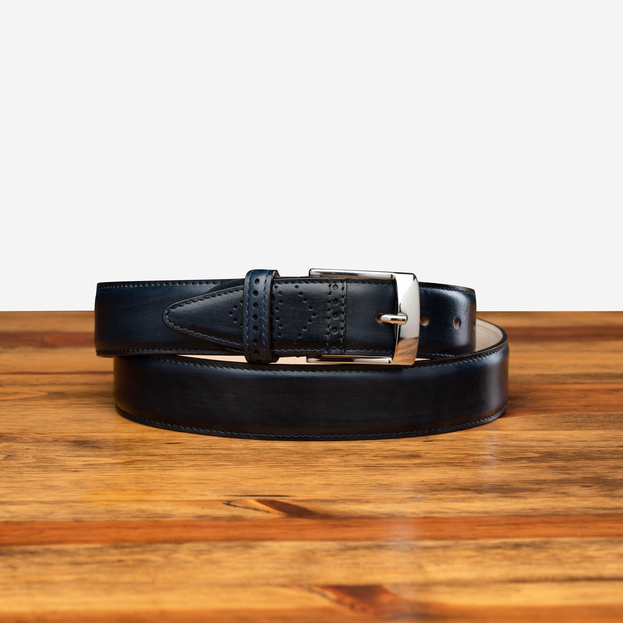 Blue leather belt with silver buckle on a wooden surface