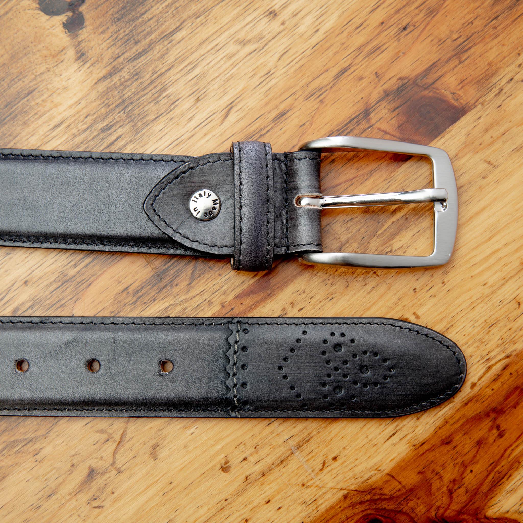 Graphite leather belt with a silver buckle on a wooden surface