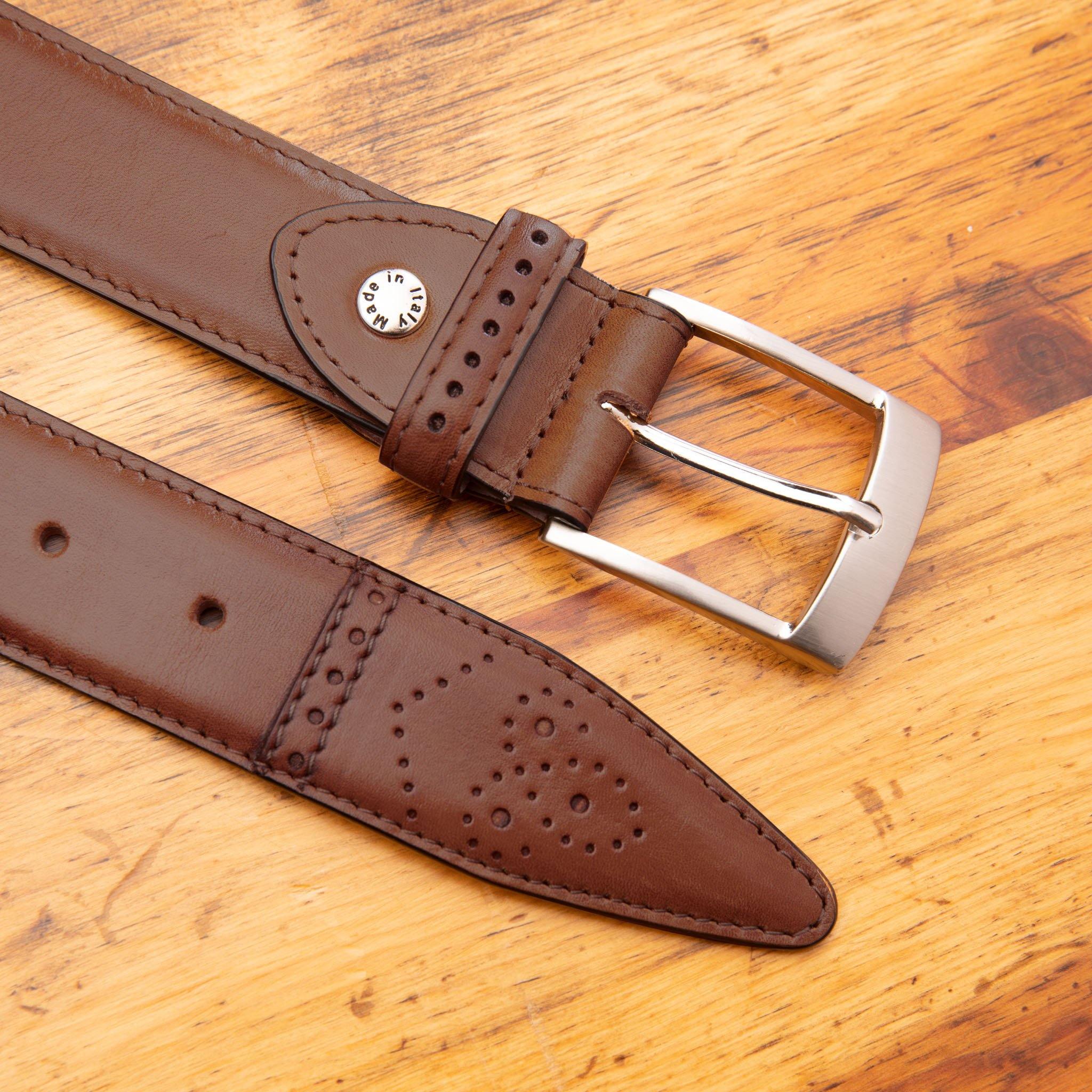 Dark Caramel leather belt with silver buckle on a wooden surface