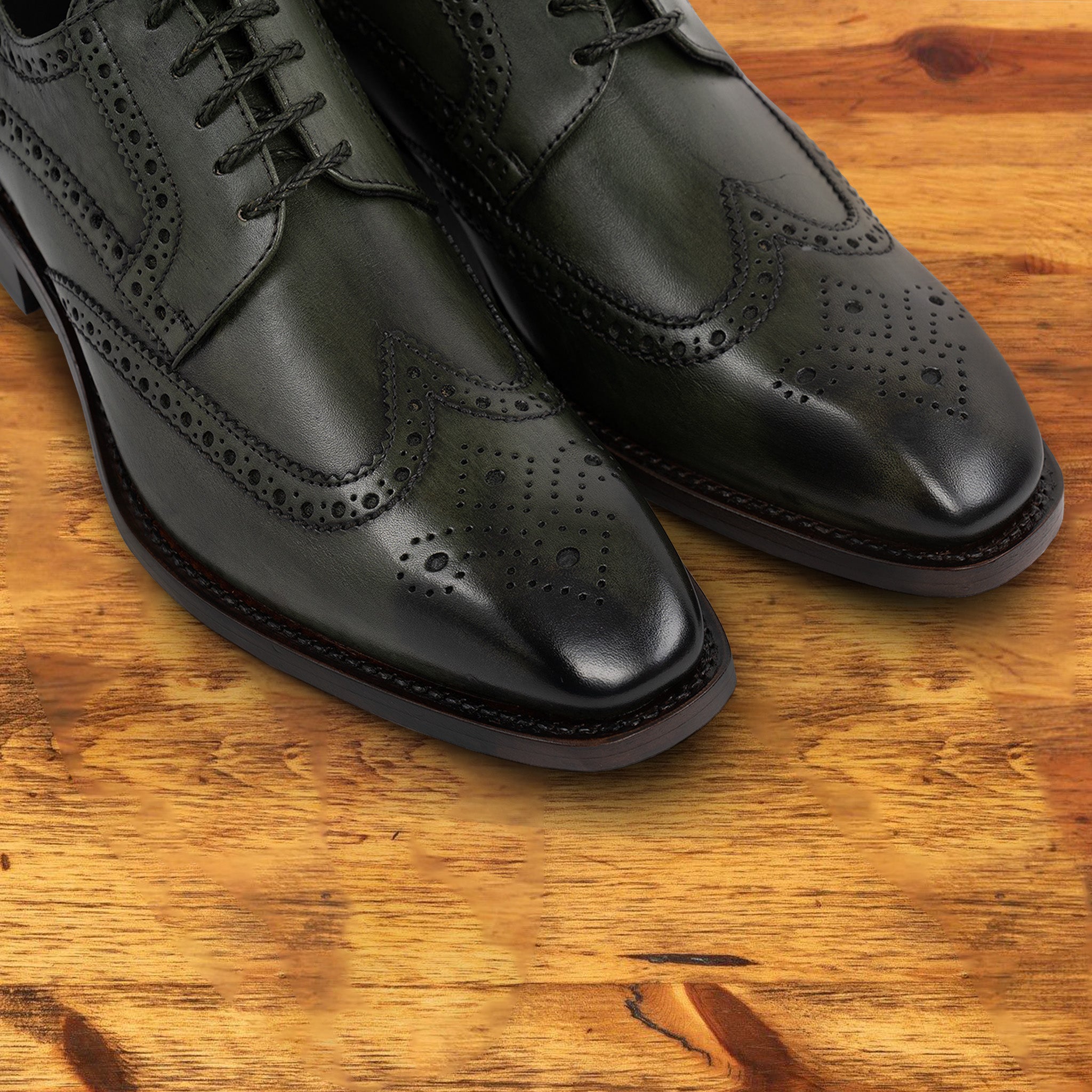 Emerald Green leather dress shoe on a wooden surface