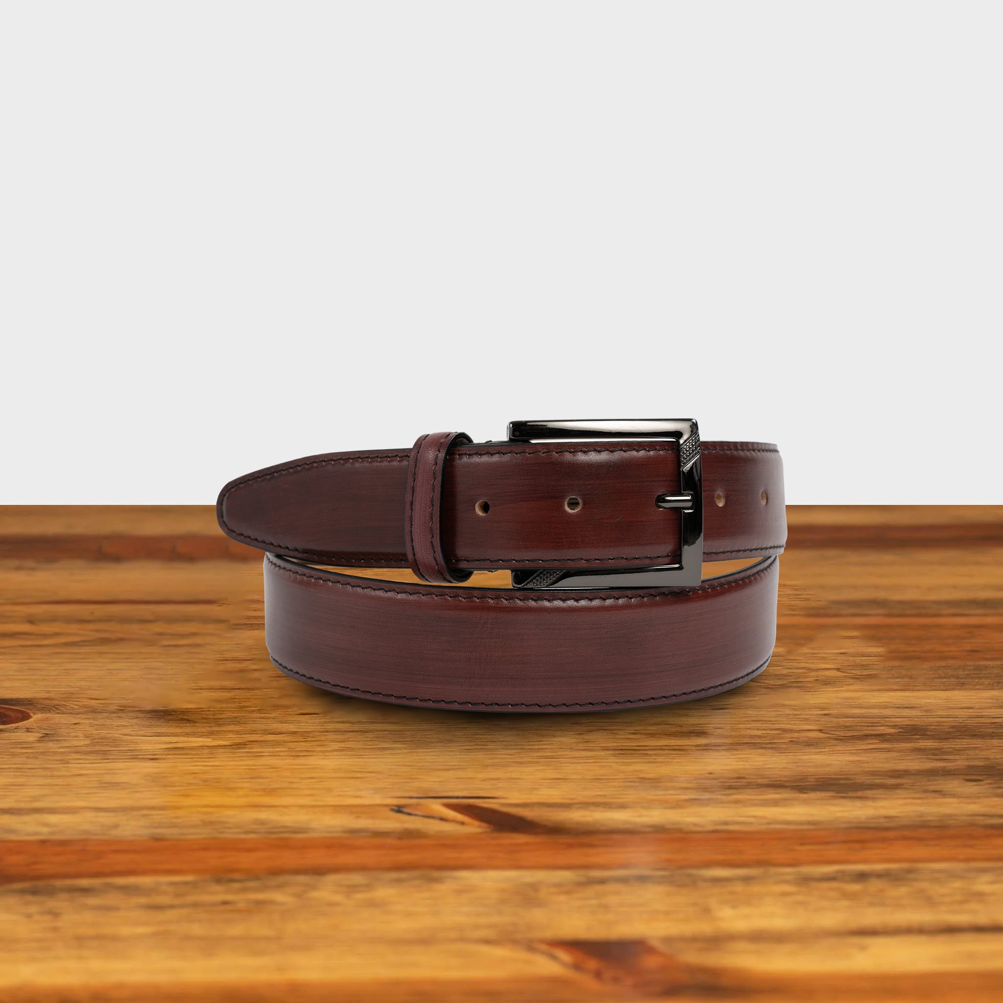 Porpora leather belt with a black buckle on a wooden surface