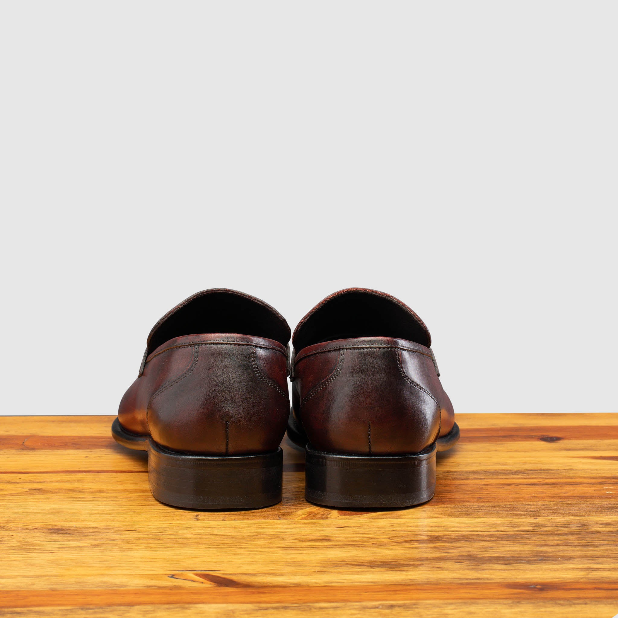 Porpora leather loafer on a wooden surface with a light gray background