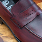 Porpora leather loafer on a wooden surface with a light gray background