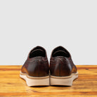 Back view of Porpora Lace Ups leather shoe on a wooden surface with a gray background