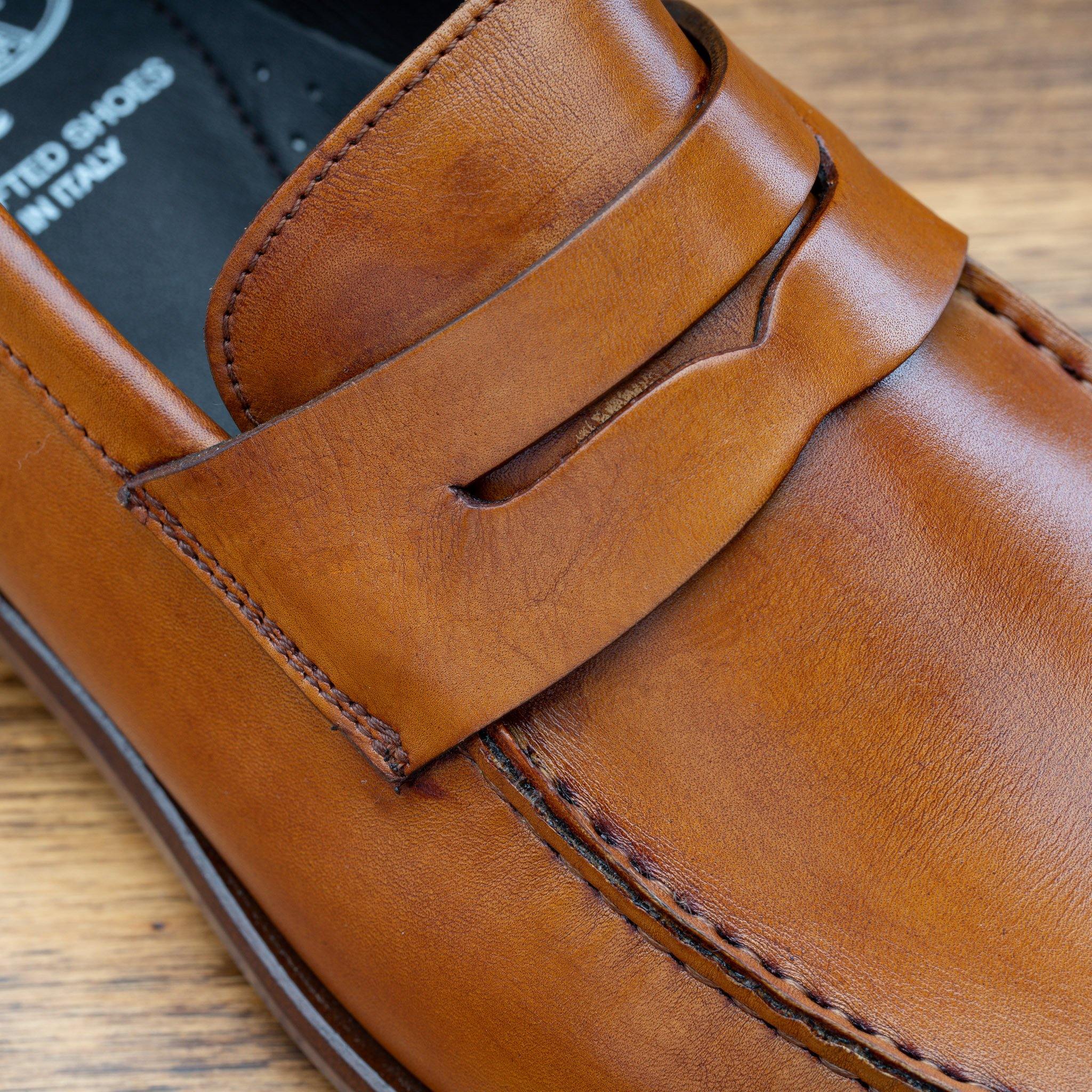 Close View of Dark Caramel leather loafer on a wooden surface