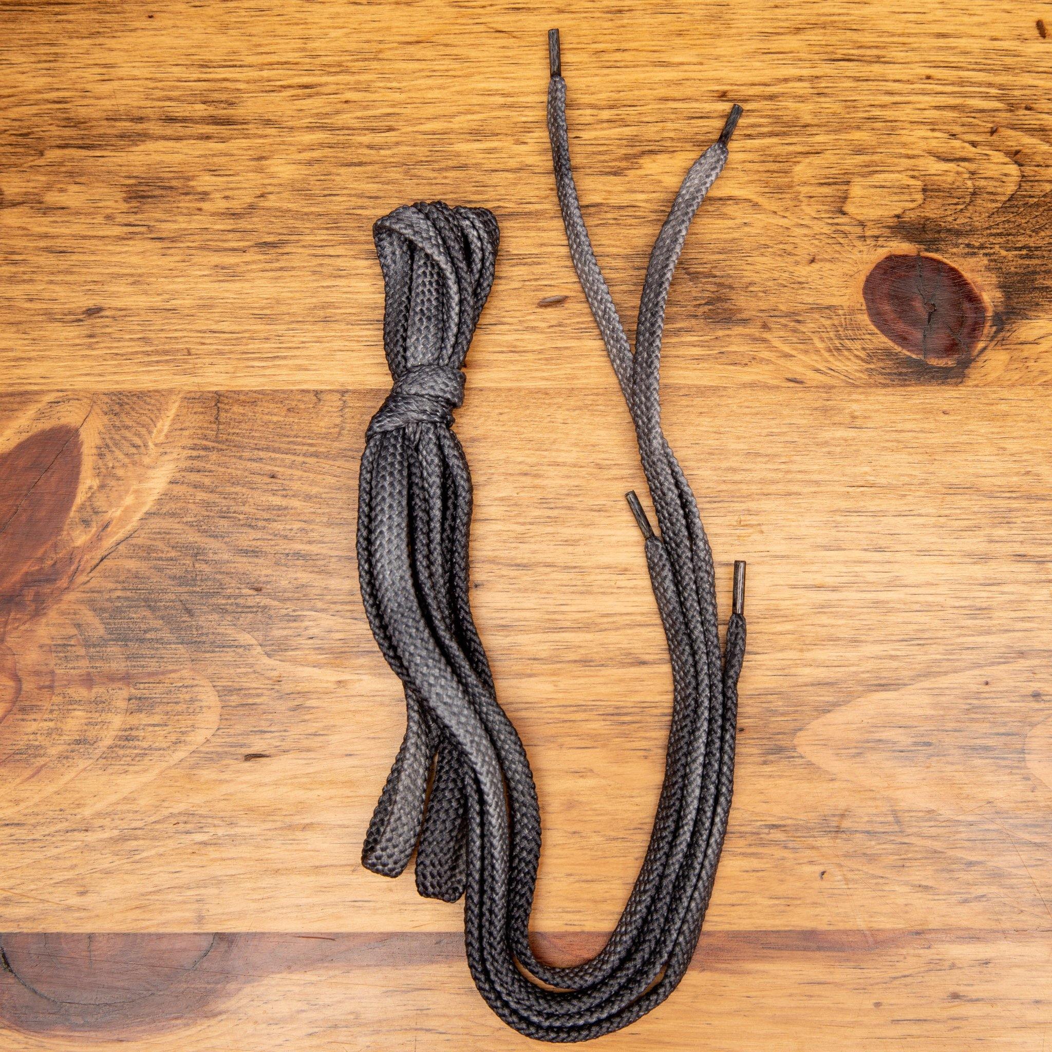 Gray shoelaces on a wooden surface