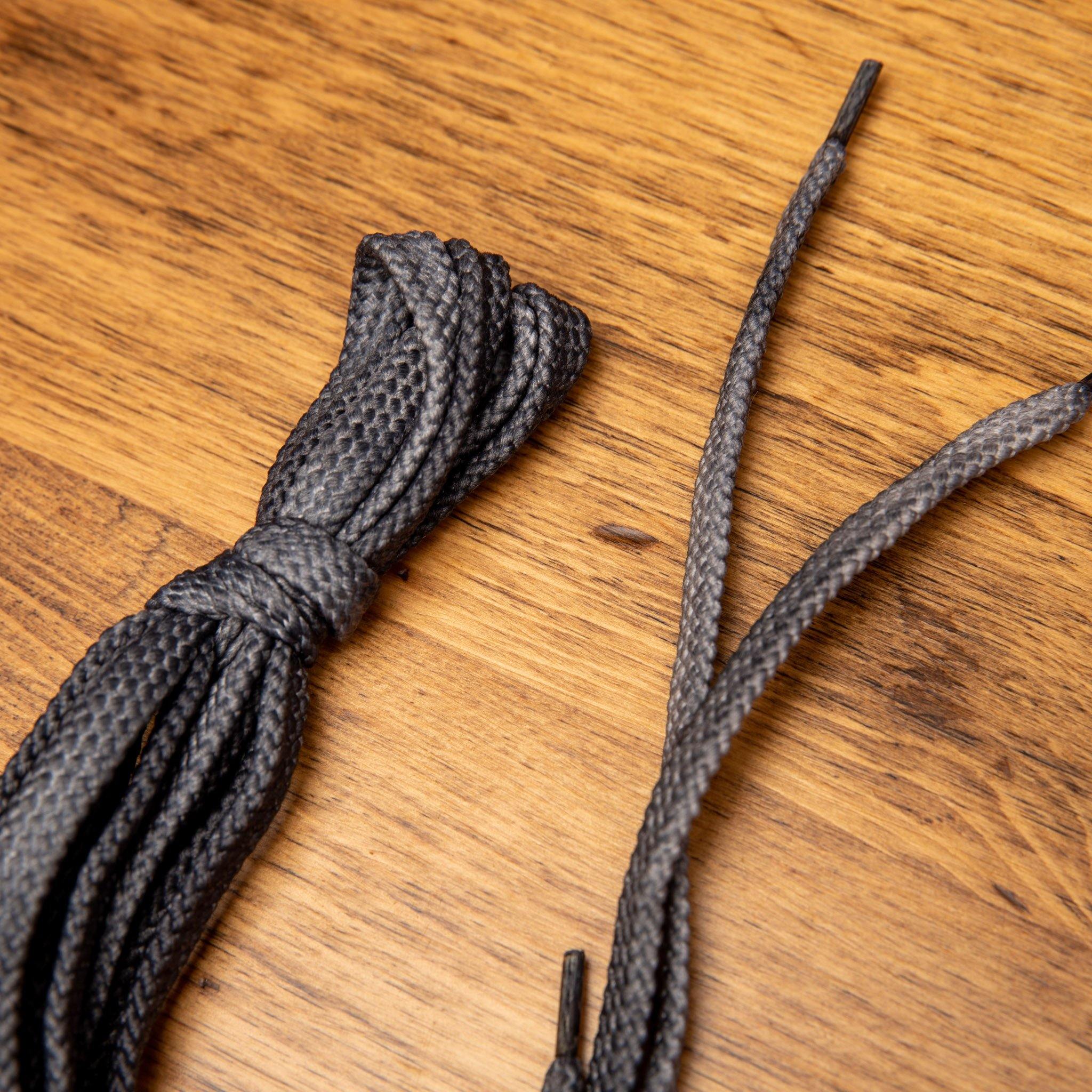 Gray shoelaces on a wooden surface