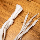 White shoelaces on a wooden surface