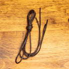 Brown shoelaces on a wooden surface