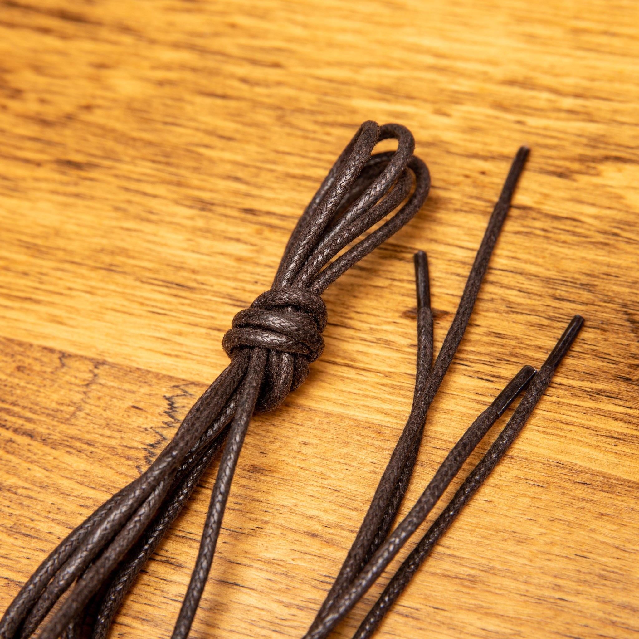 Brown shoelaces on a wooden surface