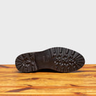 Outsole of Brown leather shoes on a wooden surface