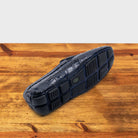 Outsole of Blue crocodile-patterned loafer on a wooden surface with a light gray background