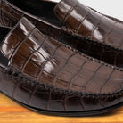 Moor crocodile-patterned loafer on a wooden surface
