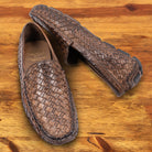 Pair of Moor loafer shoe with woven pattern on a wooden surface